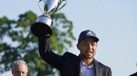 Xander Schauffele holds the trophy after winning the Travelers Championship golf tournament at TPC River Highlands, Sunday, June 26, 2022, in Cromwell, Conn.