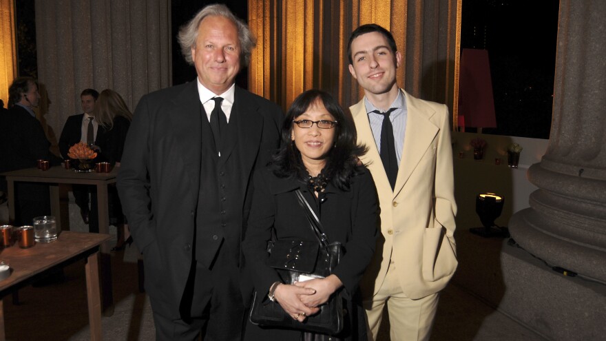 Michiko Kakutani (center) stands flanked by Vanity Fair editor Graydon Carter and his son Ash at a party in New York City in 2008.