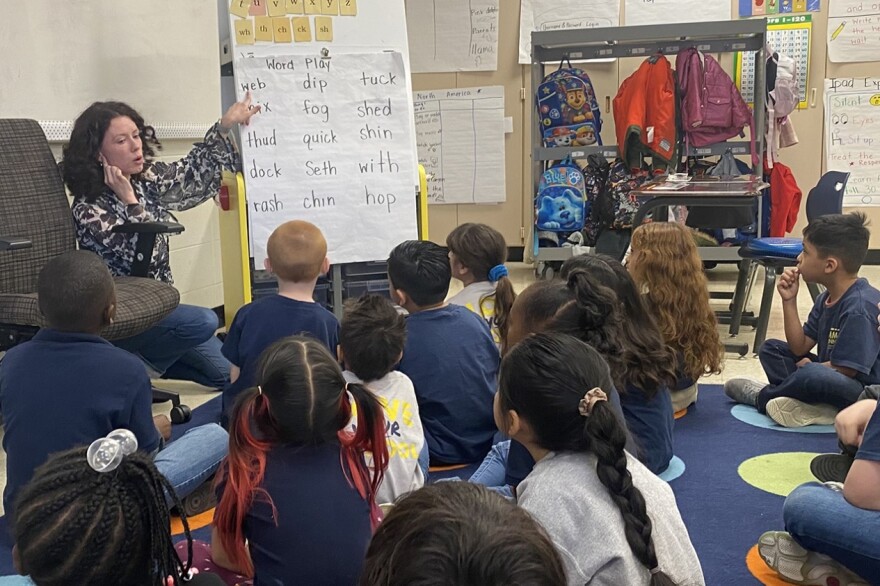 Teacher Ivy Sullivan works on reading skills with kindergarten students at Adelante charter school on Thursday, April 27, 2023 in Indianapolis.