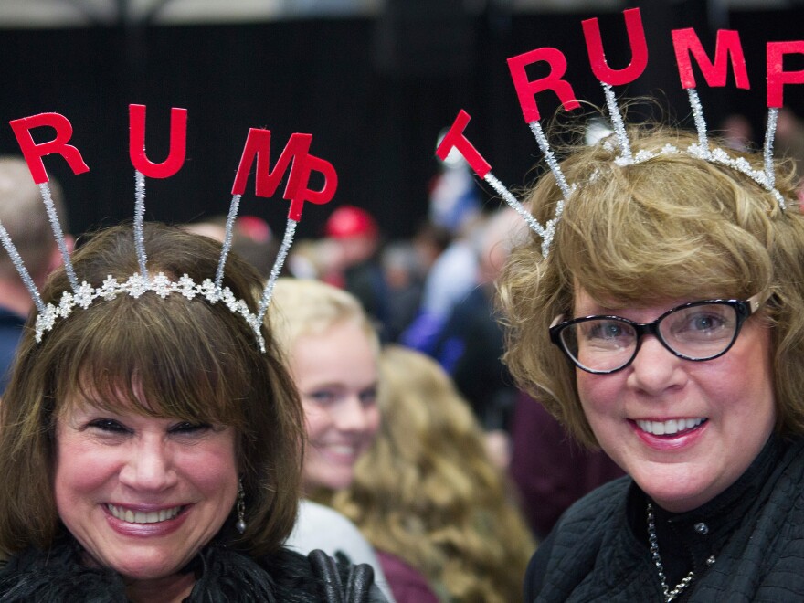 Two excited Trump supporters wait for the start of a campaign event on Monday in Grand Rapids, Mich.