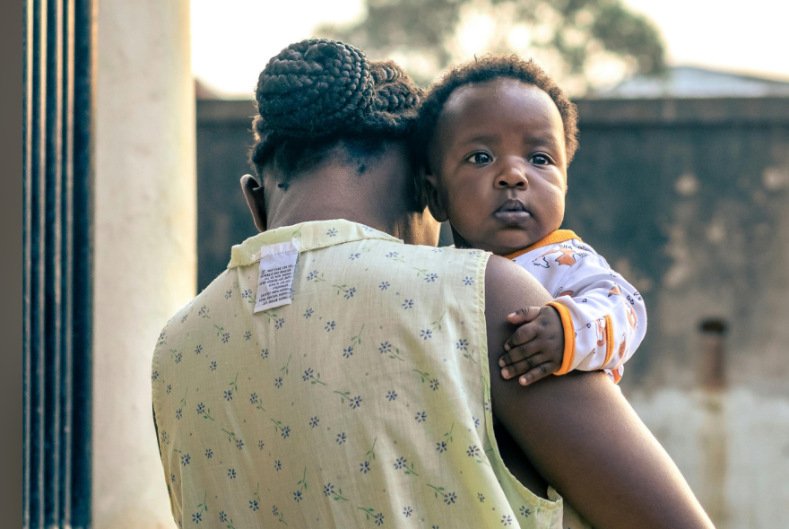A Black woman holding a baby