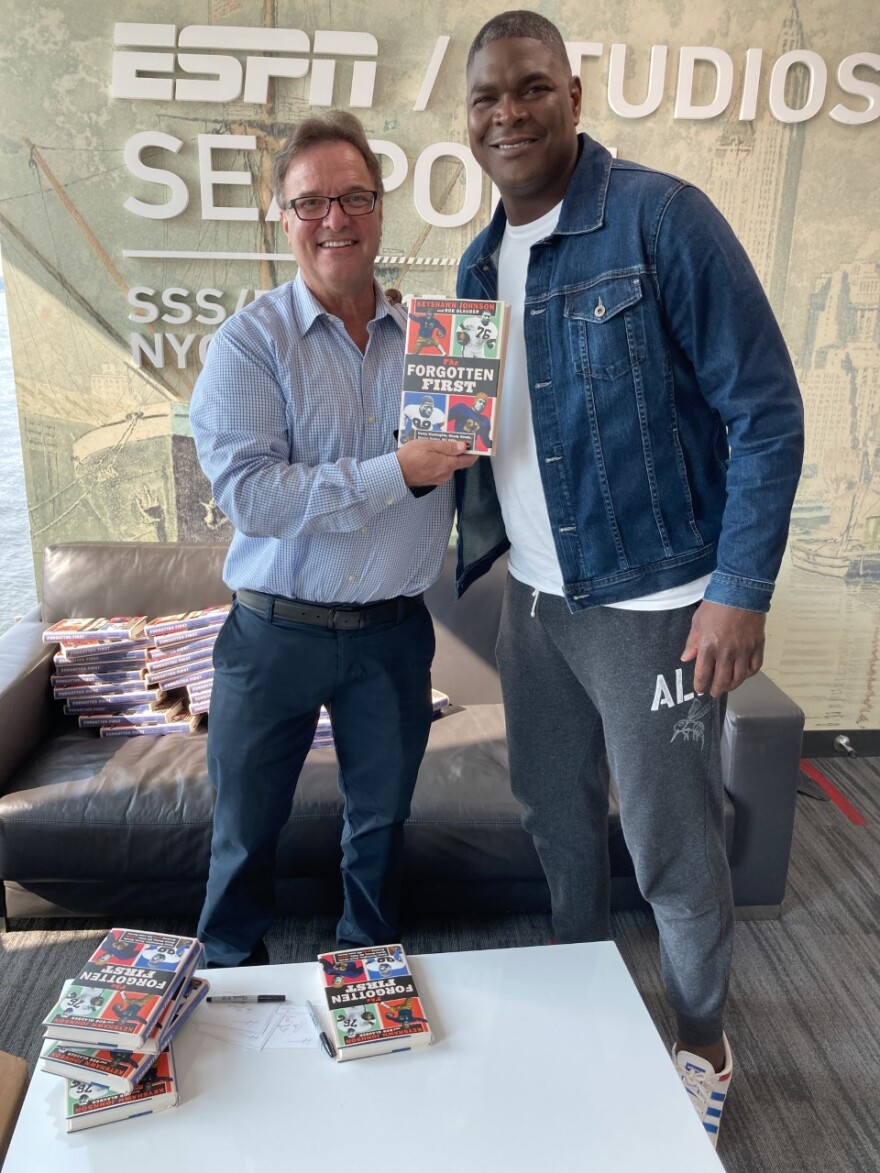 Bob Glauber and Keyshawn Johnson pose with their new book "The Forgotten First"