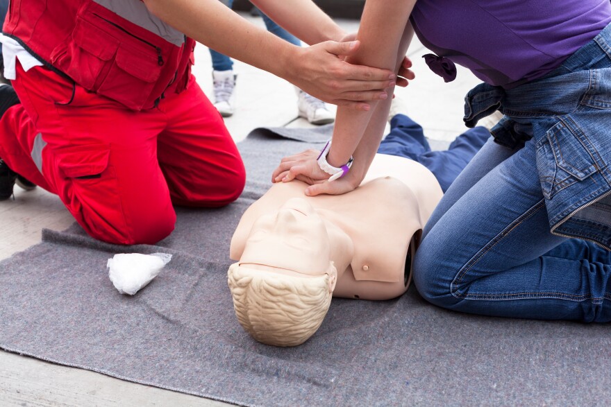 This stock image shows CPR training.