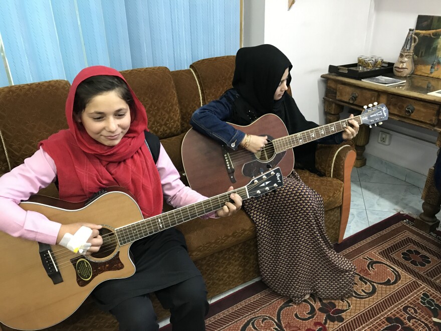Sixteen-year-old Madina Mohammadi (right), with Mursal, never attended school before teaming up with Cordola. The guitar lessons "teach me a little bit too about life," she says.
