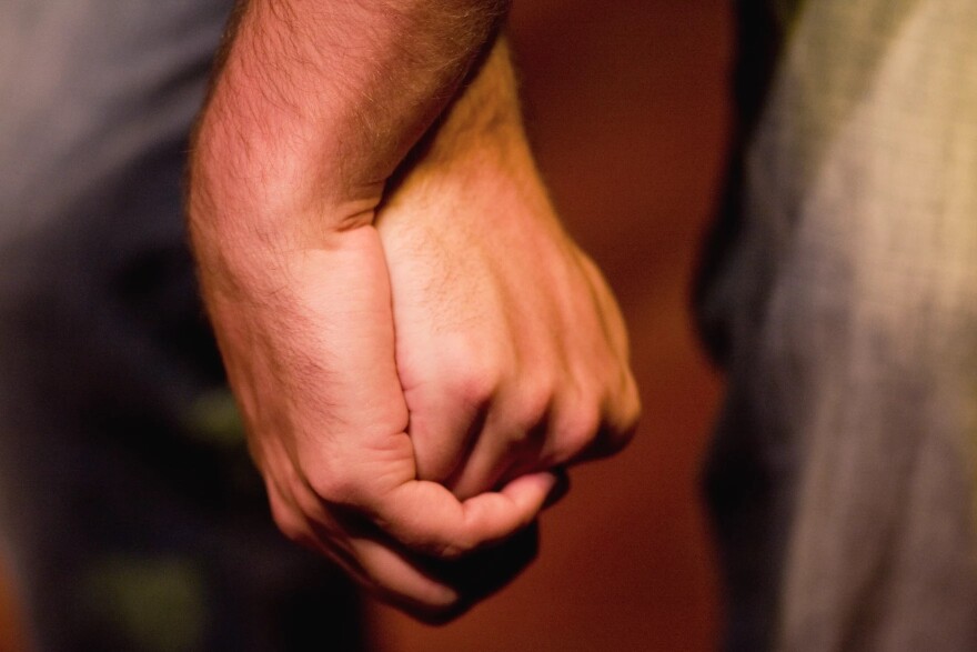 Man's hand holding another hand