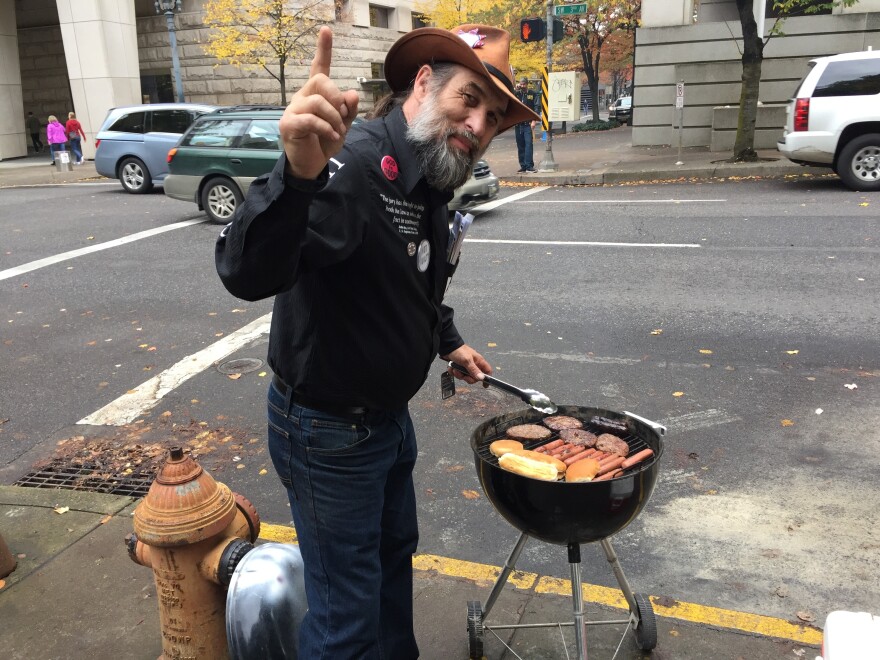 David Zion-Brugger grills hot dogs and hamburgers to pass the time while waiting for a verdict on Tuesday.