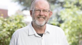 David Isaacson is looking at the camera and smiling.