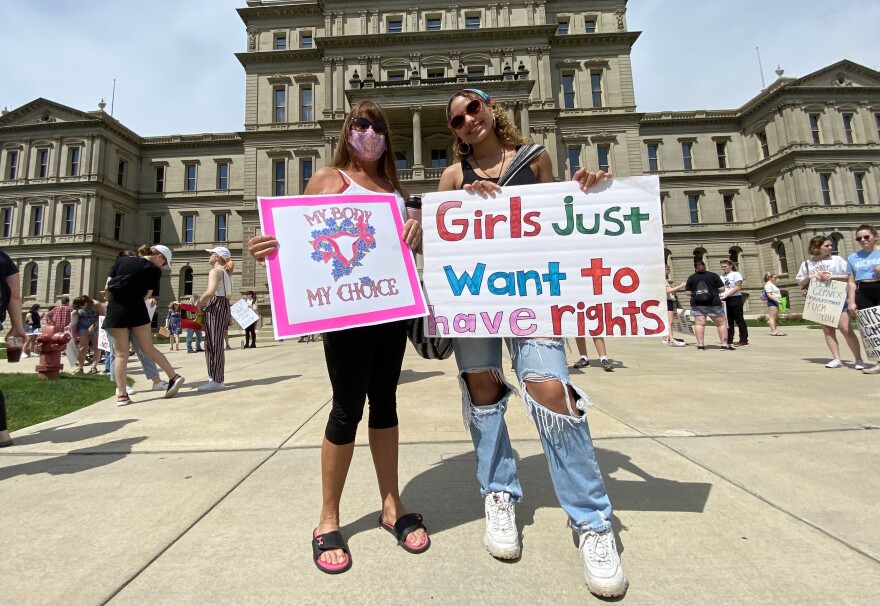 Rebecca Rau (right) poses next to Ashlynn Monroe (left) at the May 15 "Defend Roe" rally outside the Michigan State Capitol in Lansing. Rau said she was frustrated to witness the possible downfall of Roe V. Wade, but saw hope in fellow supporters like Monroe whom she just met at the rally.