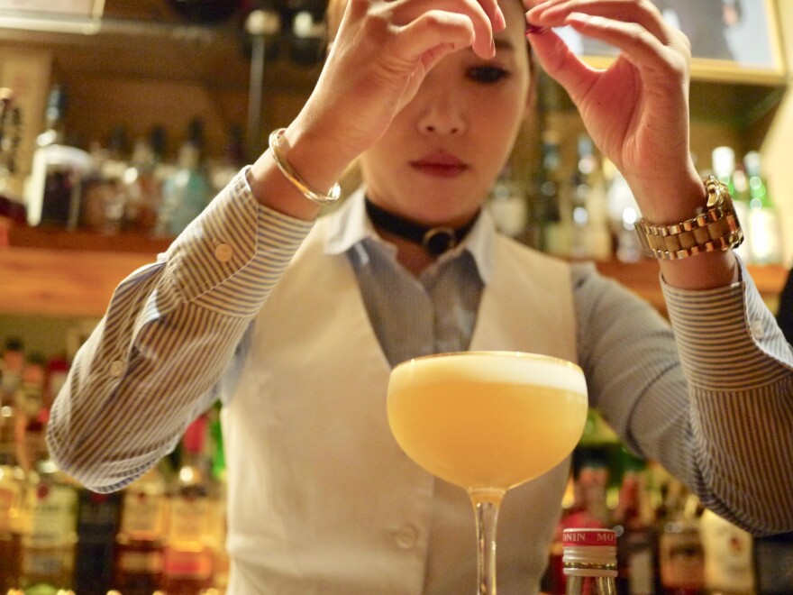 Moe mixes a Korean sour at her bar, Moju, in Shanghai. In October, she won an international cocktail competition for her signature drink, the sakura.