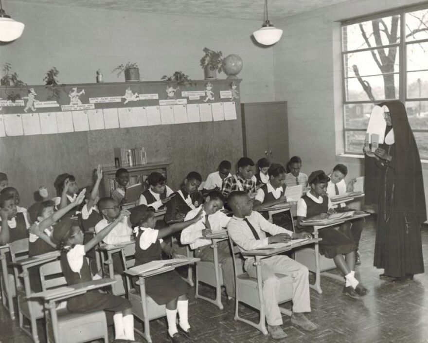 Black students study with their teacher at a school in Kinloch, Missouri, the oldest Black incorporated city in Missouri.