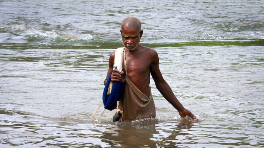 Kwame comes out of the Pru River, where he tosses his nets to catch fish. Black flies that breed in the water carry the parasite that took away his eyesight.