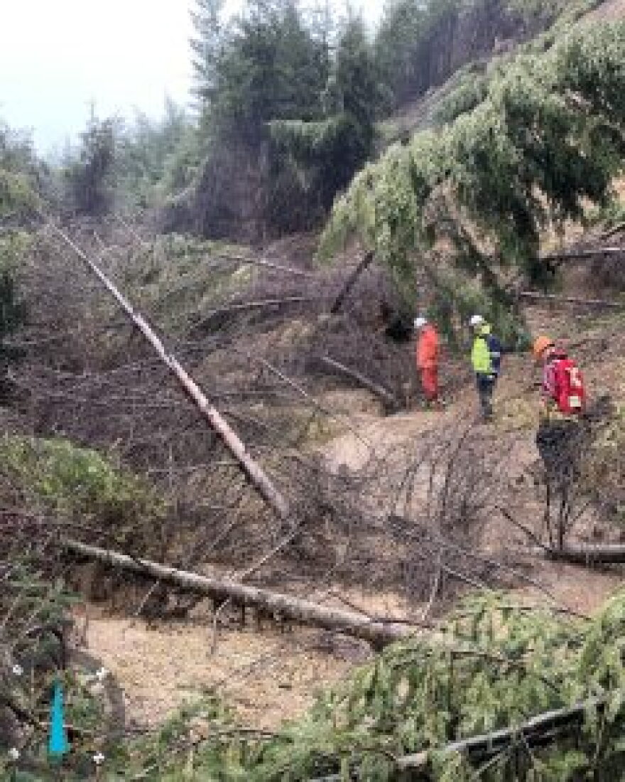 Oregon Department of Transportation engineers examine a portion of the massive slide during a visit in April. The agency says it may be years before it has a solution or rerouting of Oregon Highway 229.
