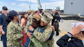 Sailors from USS Gettysburg embrace as the ship returns to Norfolk after five months.