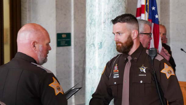 ACSD Cpl. Ben Fries accepting an award during a ceremony in 2025. He is currently the subject of a termination request by Sheriff Troy Hershberger for comments that appear to be making light of police shootings.