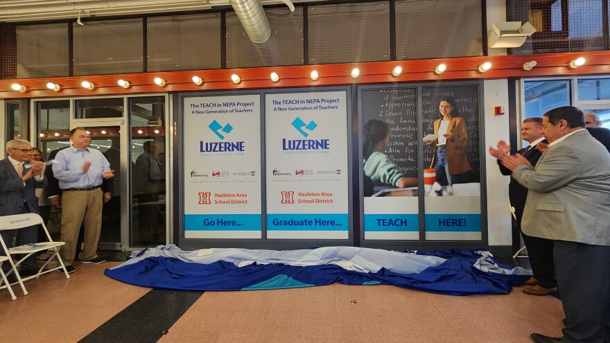 Leaders unveil new signage for the teaching program inside the Hazleton center of Luzerne County Community College.