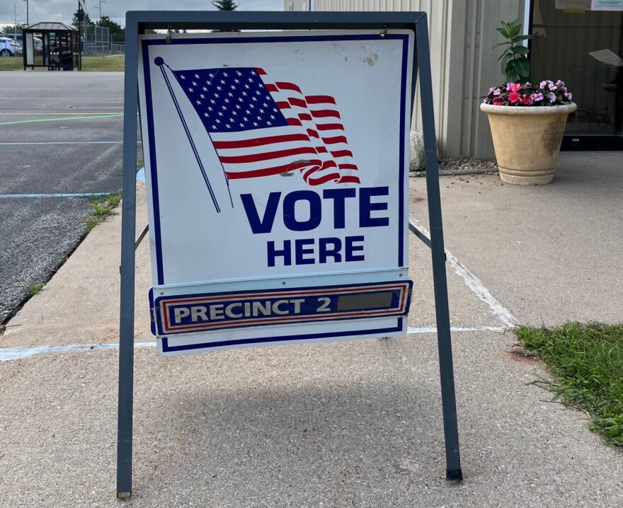 A sign reading "vote here" directs people to Blair Township's Precinct Number 2, on August 2, 2022.