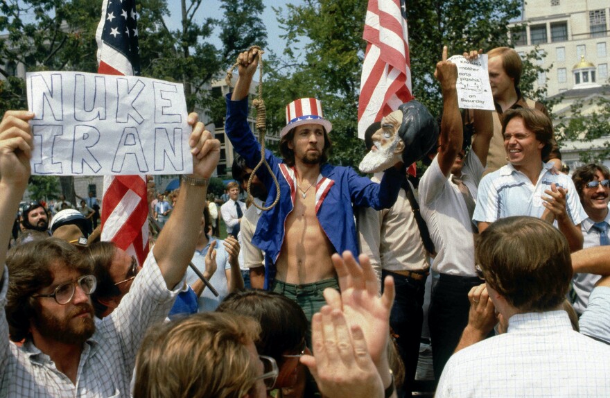 Dec. 25, 1979 - Washington, District of Columbia, U.S - Anti-Khomeini demostration in downtown DC. Protesting the takover of the US embassy in Tehran and of the holding hostage the 54 embassy employees. Police arrest one demonstrator and others yell at the police officers for protecting the Iranian students who were marching in supoort of the Khomeini government. (Credit Image: � Mark Reinstein/ZUMA Wire)