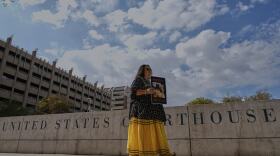 San Carlos Apache member Donna Cracium protests a massive copper mining project on federal land in Arizona outside the U.S. District Court, Wednesday, May 7, 2025, in Phoenix. (AP Photo/Matt York)