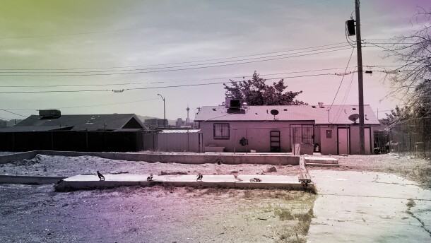 A foundation and cracked driveway where a home once stood sits in an open lot in the Windsor Park neighborhood of North Las Vegas, Nevada