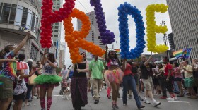 Revelers march through downtown Cincinnati during the Cincinnati Pride parade, Saturday, June 27, 2015. The day before, the U.S. Supreme Court ruled that same-sex couples have the right to marry nationwide. 