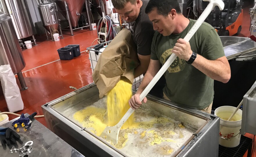 Zac Fike (L) and Matt Kehaya (R) work on a batch of beer at 14th Star Brewing Company. 14th Star donates some of its proceeds to local nonprofits.