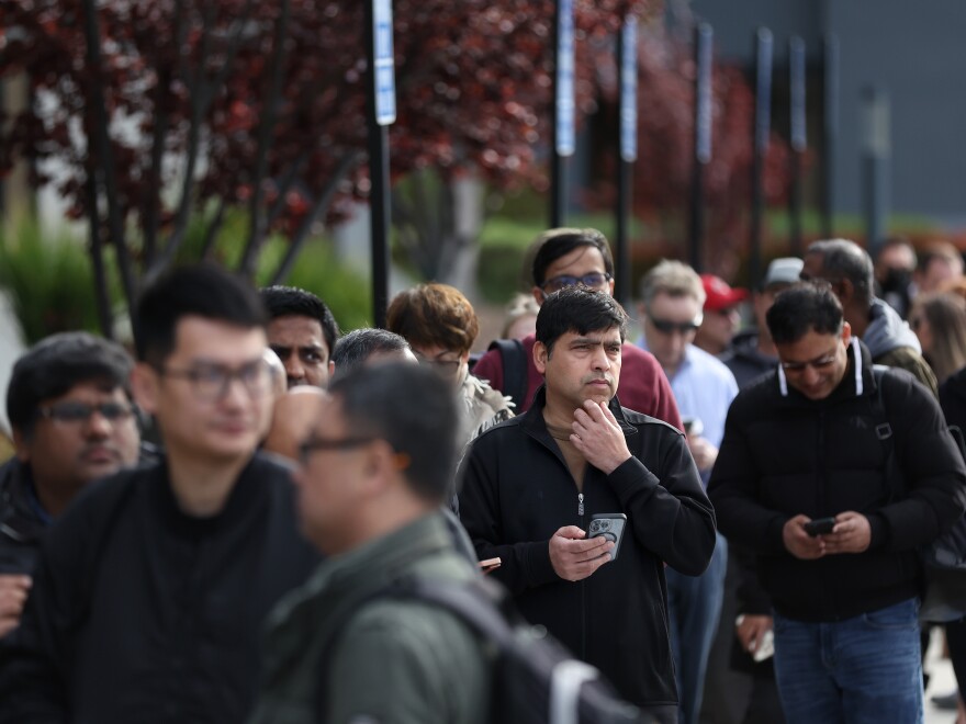 People line up outside of a Silicon Valley Bank office in Santa Clara, Calif., on March 13, 2023. in Santa Clara, California. Depositors lined up to retrieve their money even after regulators rescued the tech-focused lender.