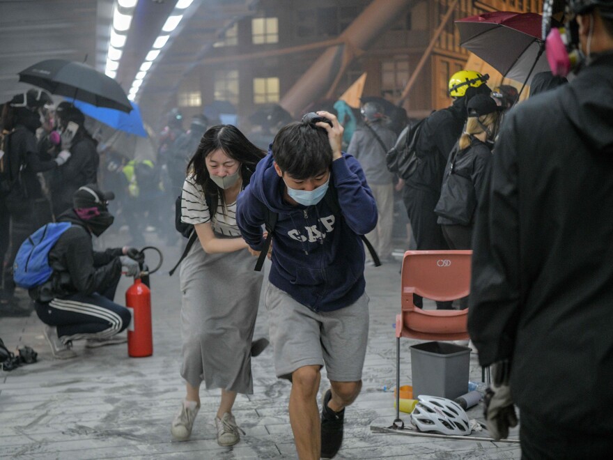 Protesters run for cover after riot police in Hong Kong on Nov. 18, 2019. Mass protests rocked the city in 2019 and 2020.