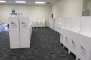 An Ada County Polling Location with white cardboard stands that have barriers between them.