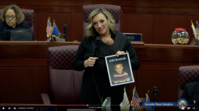 Senate Majority Leader Nicole Cannizzaro held her newborn son and a young photo of her nephew, who was graduating high school, during a Senate floor meeting on May 25, 2023. This image is a screenshot from the Nevada State Legislature’s YouTube page.
