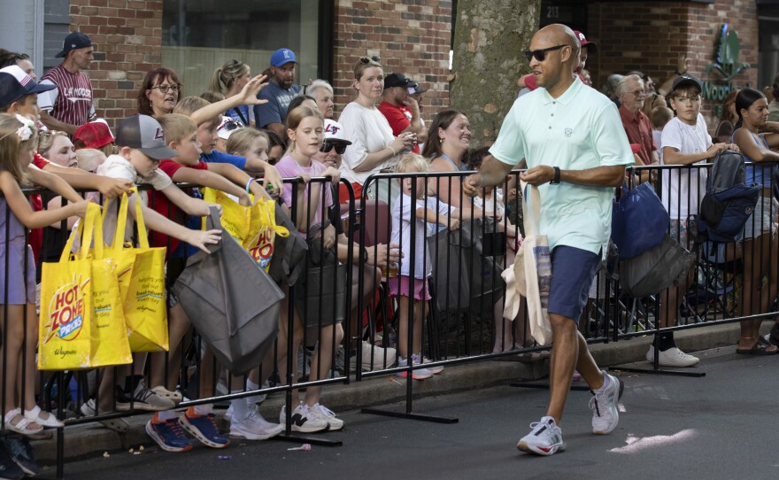 Williamsport Mayor Derek Slaughter passes out candy during the Little League World Series parade.