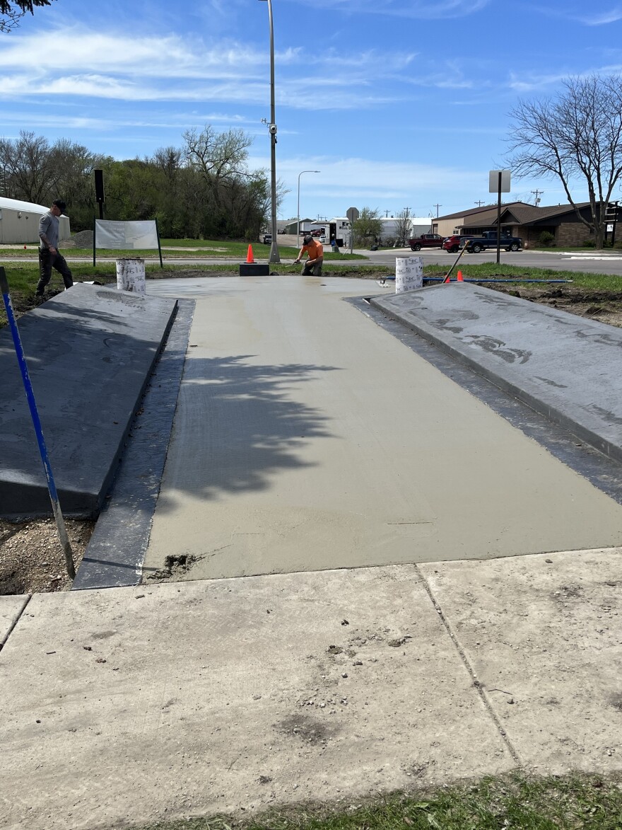 Wet cement dries as the memorial is built.
