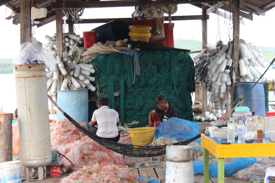 Workers clean out bycatch from nets on a dock in Koh Sdach, an island in Cambodia’s Koh Kong province. Illegal fishing threatens traditional fishing villages and marine ecosystems in Cambodia. Artificial reefs are being used to fight back.