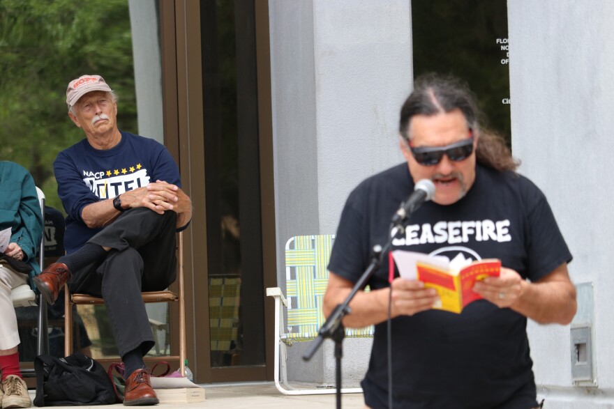 Dan Harmeling (left) listens attentively to Dr. Paul Ortiz read an excerpt from Kurt Vonnegut’s “Slaughtehouse-Five.” (Alex Winn/WUFT News)