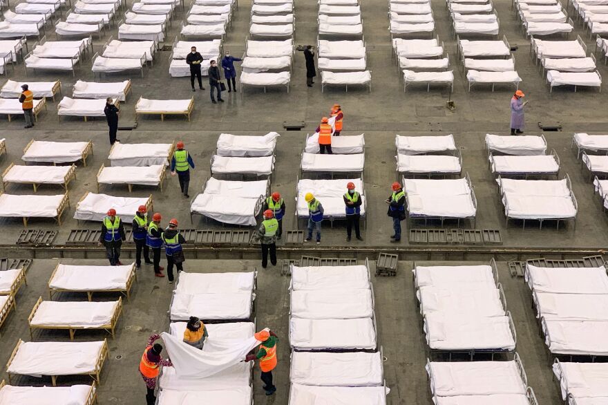 Workers set up beds at an exhibition center that was converted into a hospital in Wuhan, in China's central Hubei province, on Feb. 4.