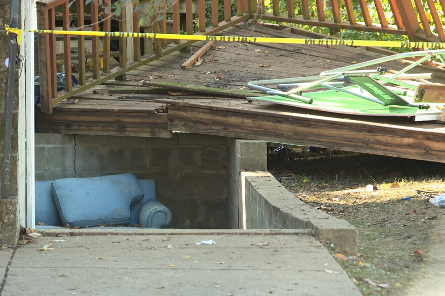 An underground area beneath a collapsed deck