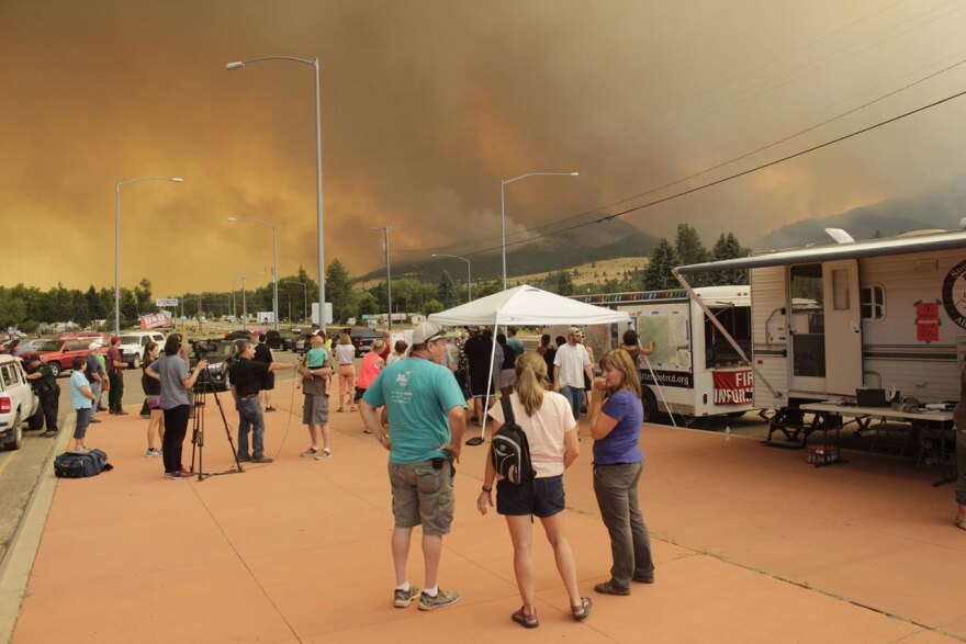 Lolo area residents gather at an incident command site Friday, August 18 as evening winds stoke the Lolo Peak Fire.