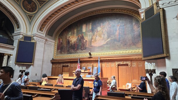 Tourists of the Wisconsin Legislature walk through the Assembly chamber where state laws are passed.