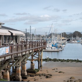 A view of the Old Fisherman's Wharf in Monterey with the harbor behind it.