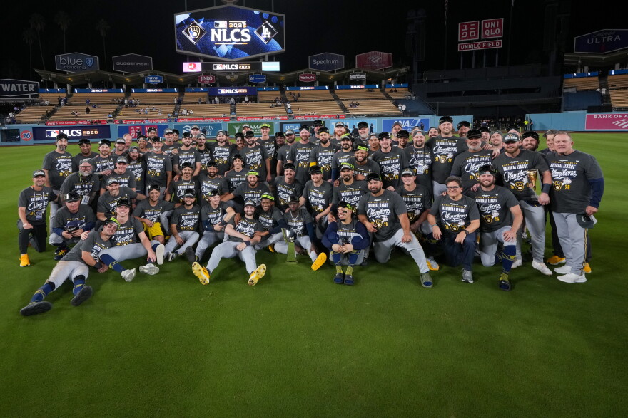 Milwaukee Brewers players and staff pose together at Dodger Stadium after winning the 2026 National League Championship Series