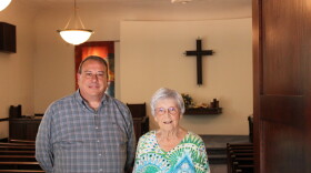 A man and older woman stand next to each other in North Danvers Mennonite Church