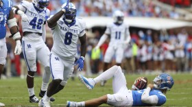 Kentucky defensive lineman Octavious Oxendine (8) reacts after sacking Mississippi quarterback Jaxson Dart (2) during the first half of an NCAA college football game against Mississippi Saturday, Sept. 28, 2024, in Oxford, Miss. (AP Photo/Randy J. Williams)