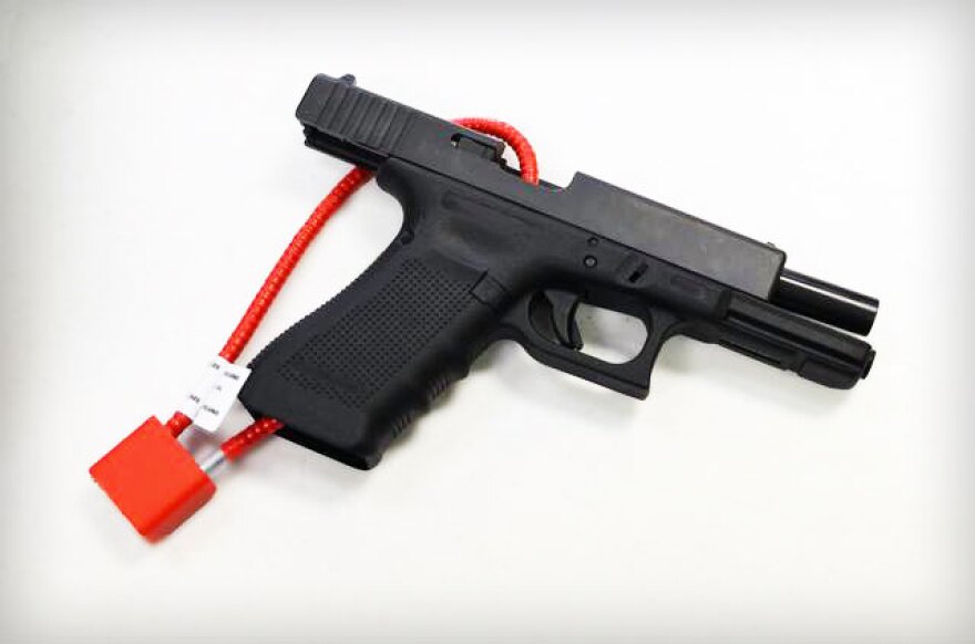 A firearm with a cable lock attached