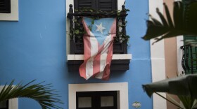 A Puerto Rican flag hangs from the balcony of a house in San Juan, Puerto Rico, on May 1.