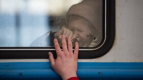 A young girl cries as a man says goodbye to his daughter at the railway station on March 22, 2022 in Lviv, Ukraine. (Alexey Furman/Getty Images)