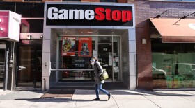 People walk by a GameStop store in Brooklyn on January 28, 2021 in New York City. Markets continue a volatile streak with the Dow Jones Industrial Average rising over 500 points in morning trading following yesterdays losses. Shares of the video game retailer GameStop plunged. (Spencer Platt/Getty Images)