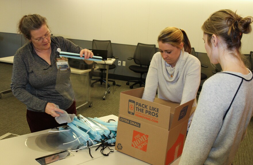 Staff of Providence St. Joseph Health assembles face shields at the health care system's headquarters in Renton, Wash., to bolster the supply of personal protective equipment at nearby hospitals.