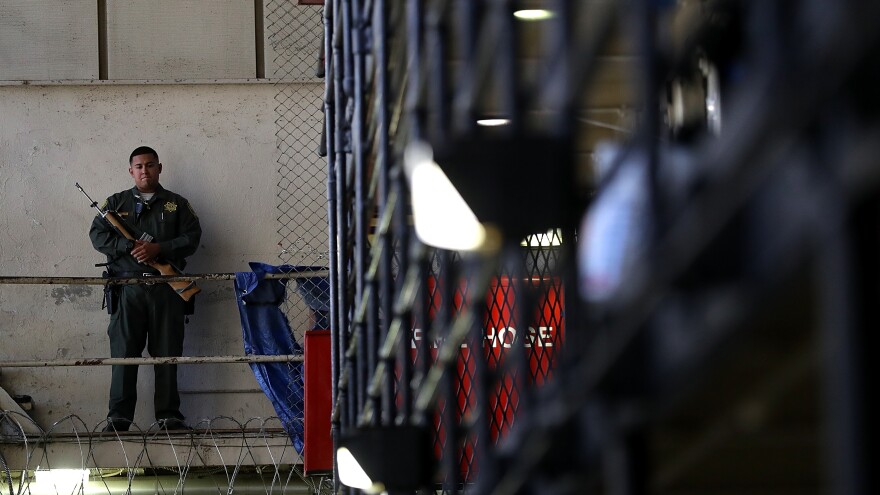 An armed California Department of Corrections and Rehabilitation officer stands guard at San Quentin State Prison's death row.