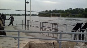 Water rises on to the platform of the labor statue on the Omaha riverfront.