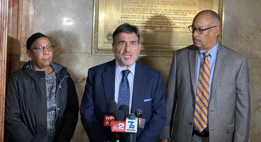 Matthew Bergman (center), John Elmore of John V. Elmore, P.C. and Barbara Massey, sister of Tops shooting victim Kat Massey speak with media ahead of Friday's wrongful death lawsuit hearing