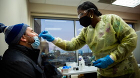 Travel nurse Stacey Solomon, of Lake City, Fla., administers a COVID-19 test to Michael Failoni, 29, of Edwardsville, on Monday, Jan. 3, 2022, at a testing site in Grand Center. Solomon estimates health care workers have given as many as 1,000 coronavirus tests a day as the nation sees a surge of the omicron variant.  